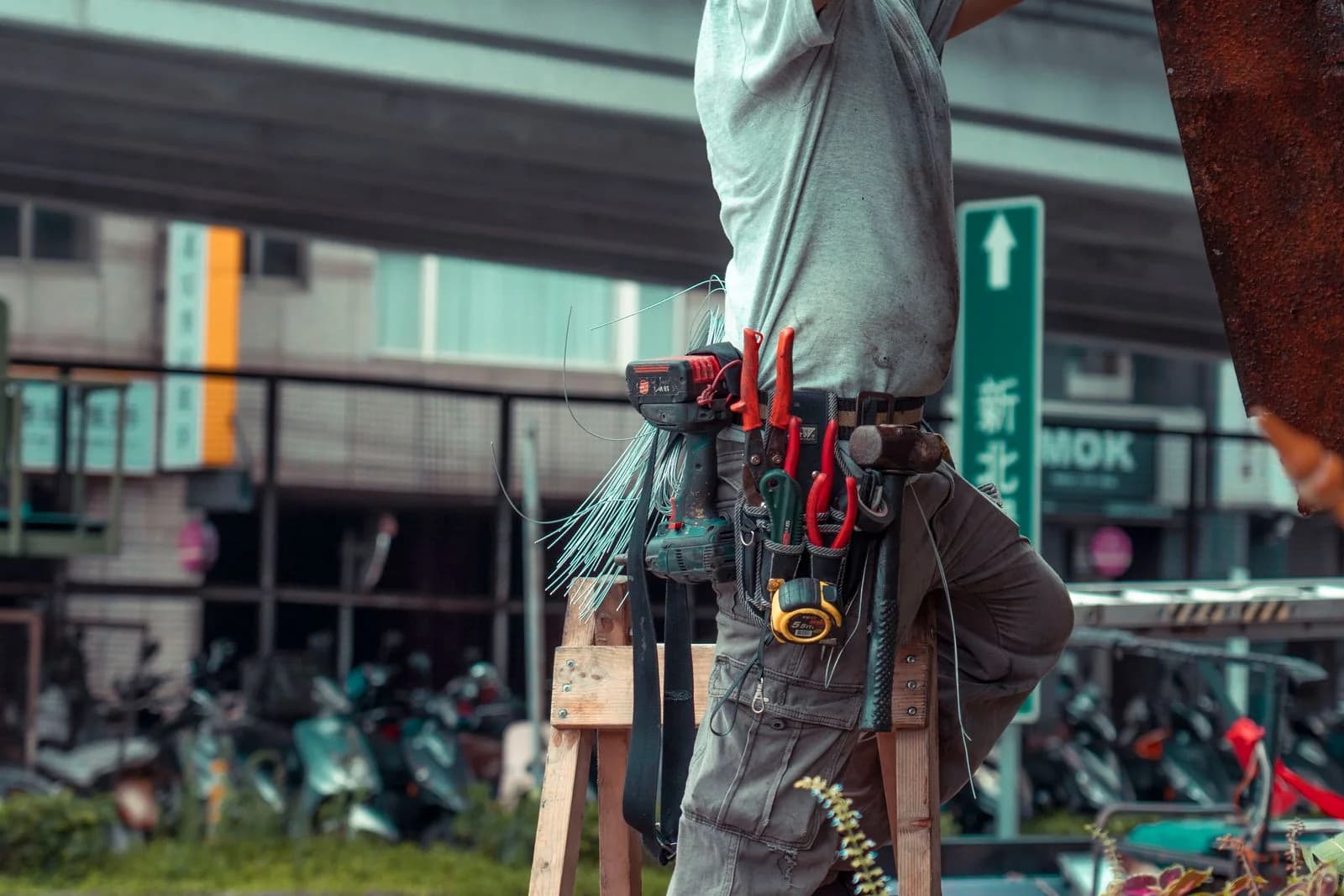 Tradesperson wearing a tool belt outdoors